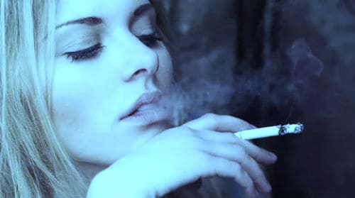Женщина курит.